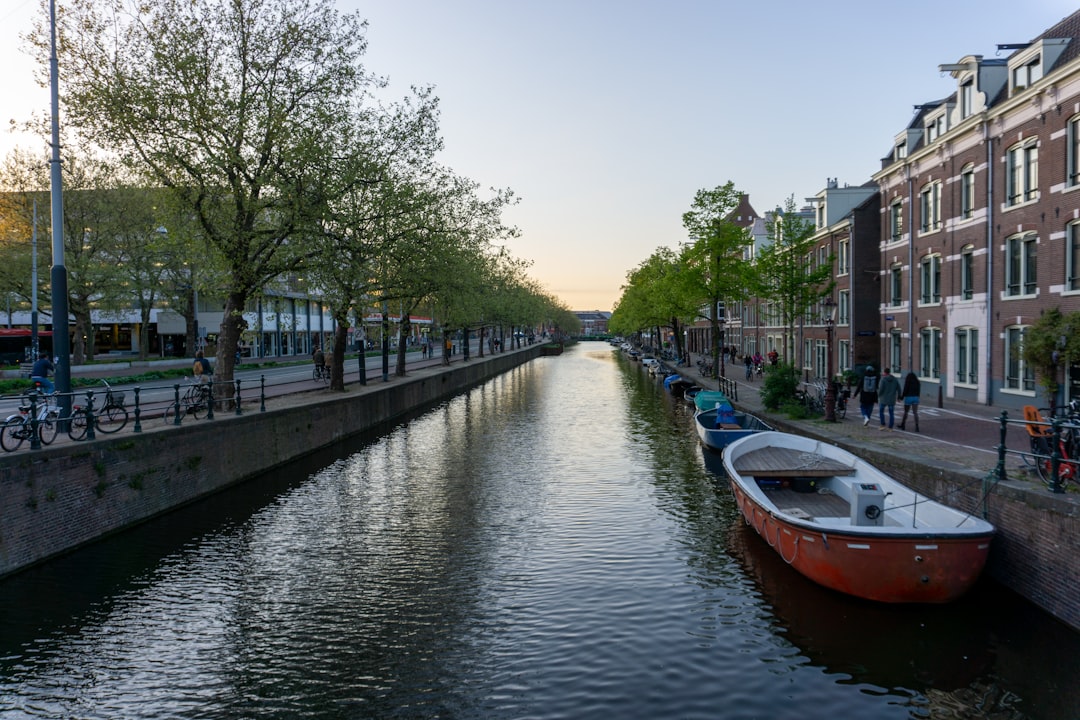 a boat is parked on the side of a canal
